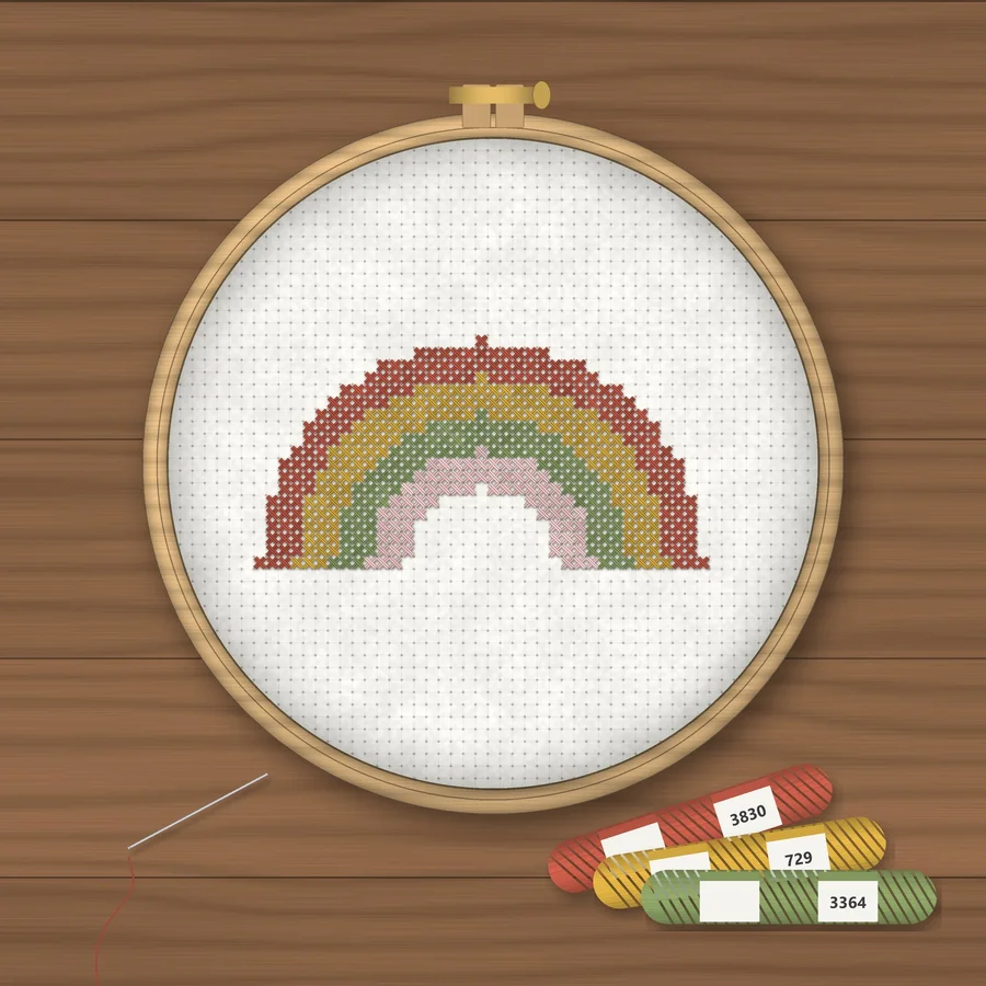Boho Rainbow cross stitch finished in a wooden embroidery hoop with DMC thread skeins