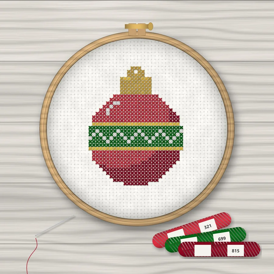 Christmas Ornament cross stitch finished in a wooden embroidery hoop with DMC thread skeins