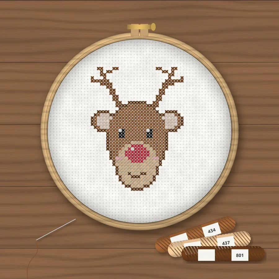 Christmas Reindeer cross stitch finished in a wooden embroidery hoop with DMC thread skeins