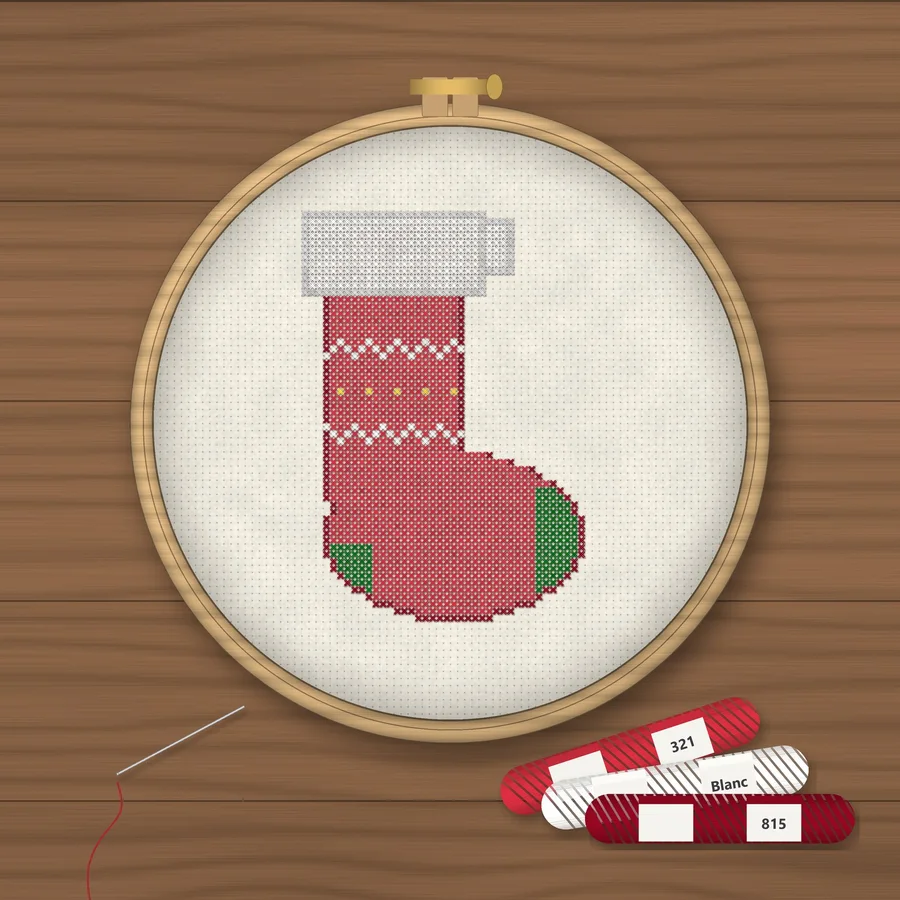 Mini Christmas Stocking cross stitch finished in a wooden embroidery hoop with DMC thread skeins