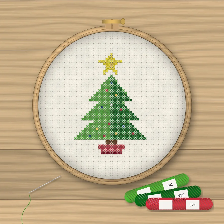 Christmas Tree cross stitch finished in a wooden embroidery hoop with DMC thread skeins