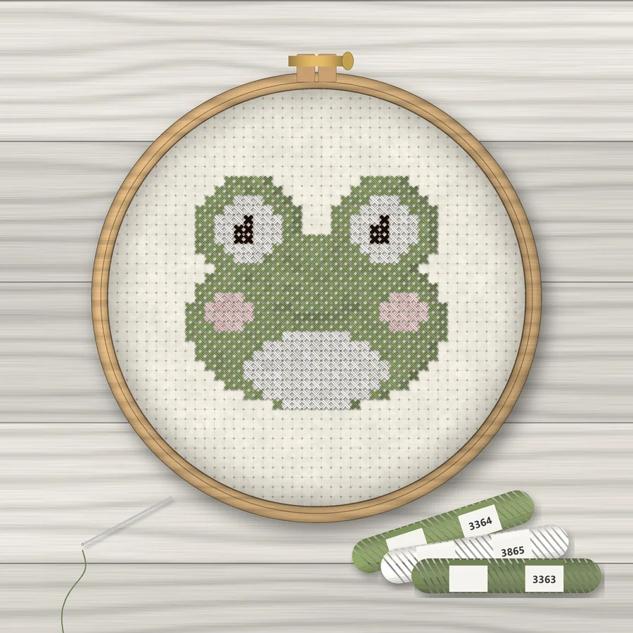 Cute Frog cross stitch finished in a wooden embroidery hoop with DMC thread skeins