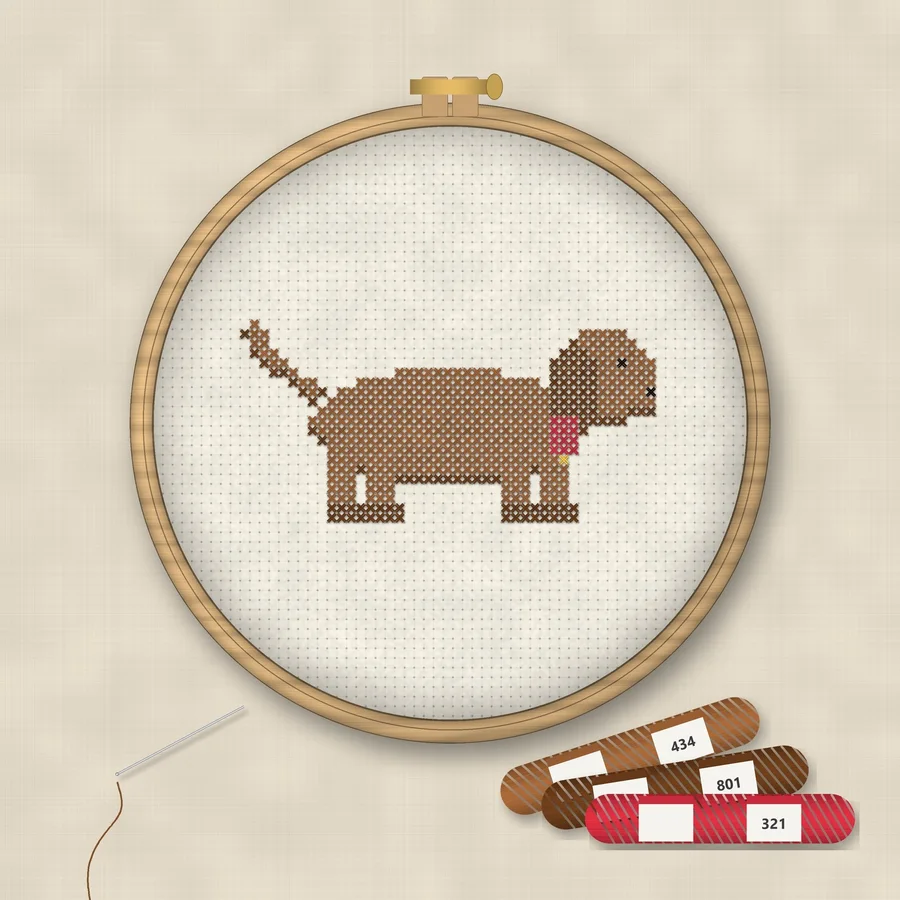 Dachshund cross stitch finished in a wooden embroidery hoop with DMC thread skeins