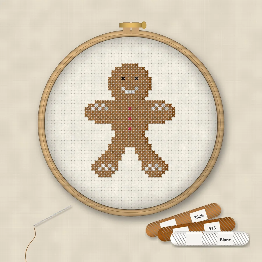 Gingerbread Man cross stitch finished in a wooden embroidery hoop with DMC thread skeins