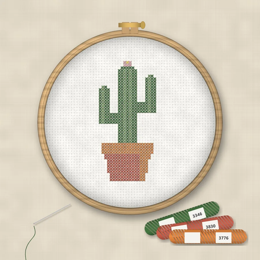 Potted Cactus cross stitch finished in a wooden embroidery hoop with DMC thread skeins