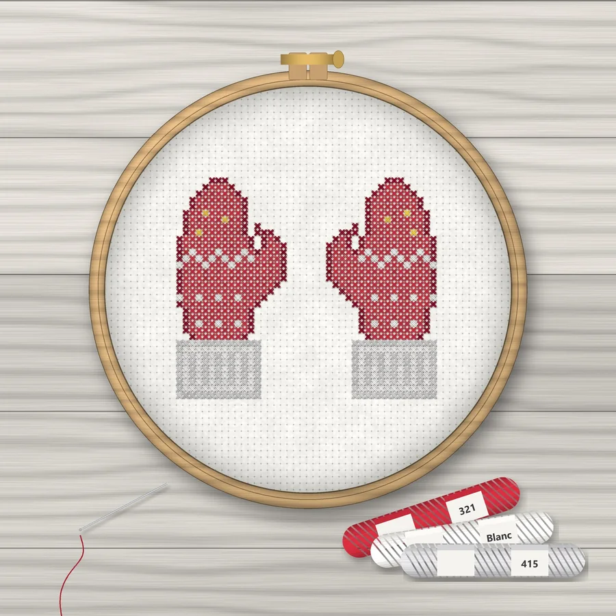 Winter Mittens cross stitch finished in a wooden embroidery hoop with DMC thread skeins